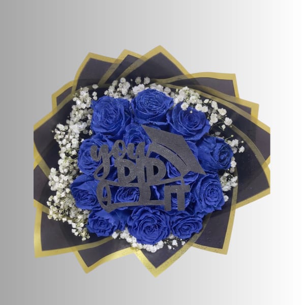 Blue roses with white baby's breath and a graduation topper