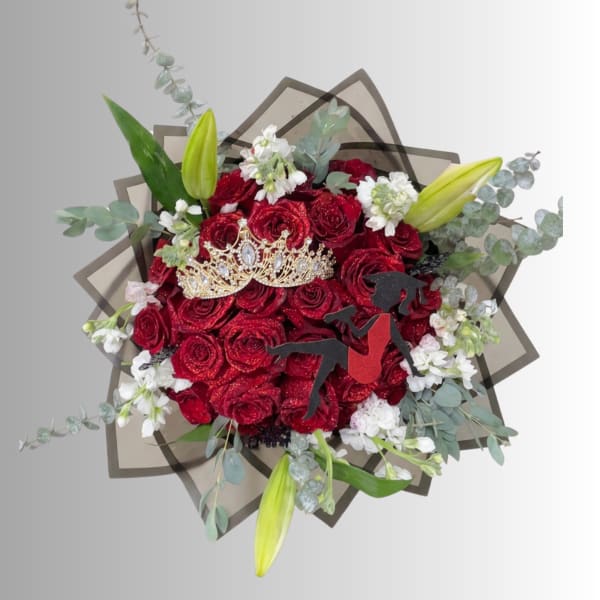Red rose bouquet with white accents, lilies, and a decorative crown