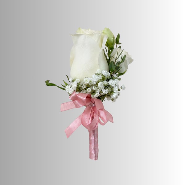 White rose boutonniere with baby's breath and pink ribbon