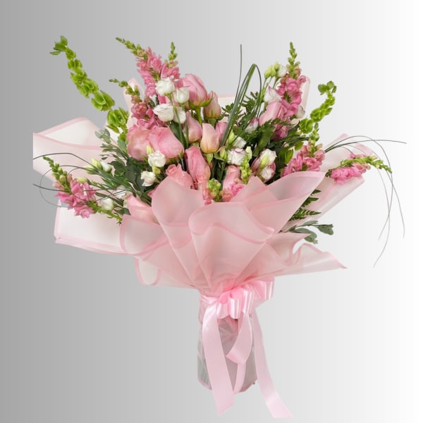 Pink and white mixed bouquet wrapped in sheer pink paper with ribbon