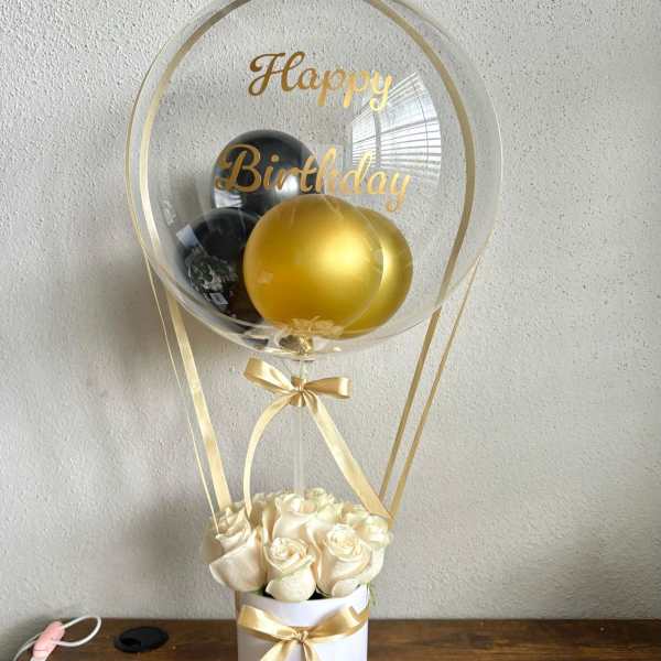Cream roses in a white box with gold birthday balloons