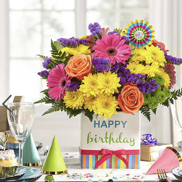 Birthday flower arrangement in a decorated gift box with bright mixed blooms