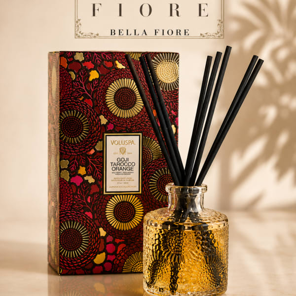 Decorative reed diffuser in a textured glass bottle with a patterned box