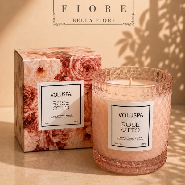 Pink rose-scented candle in a textured glass jar with matching box