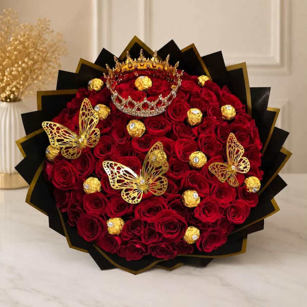 Bouquet of red roses with gold butterfly decorations and chocolates