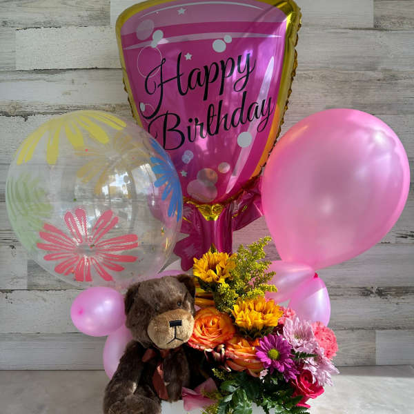 Birthday balloon bouquet with flowers and a teddy bear