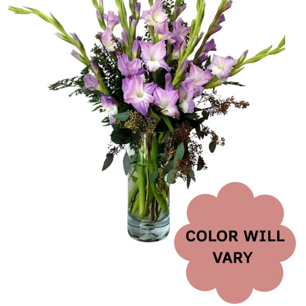 Tall lavender flower arrangement in a clear glass vase