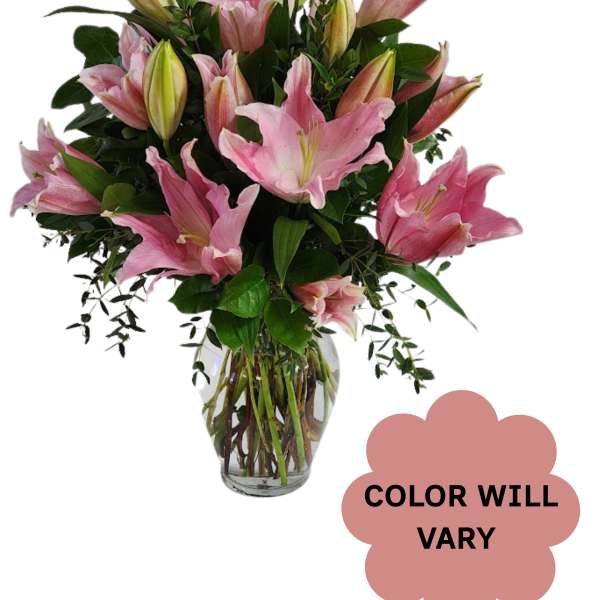 Pink lilies arranged in a clear glass vase
