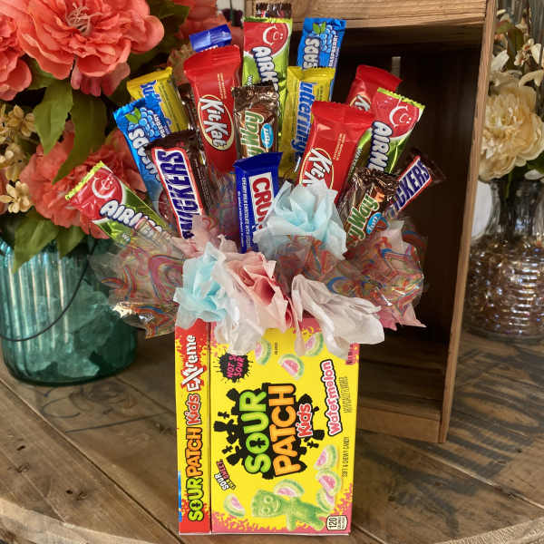 Candy bouquet in a Sour Patch Kids box with colorful wrapped sweets