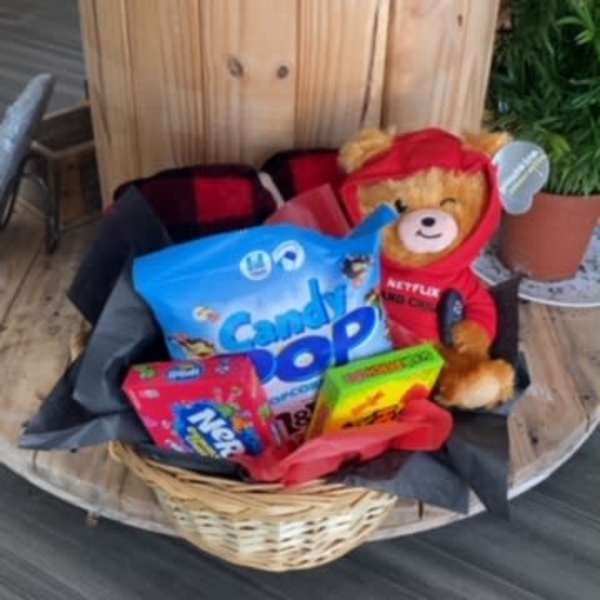 Basket of candy with a teddy bear in a red hoodie