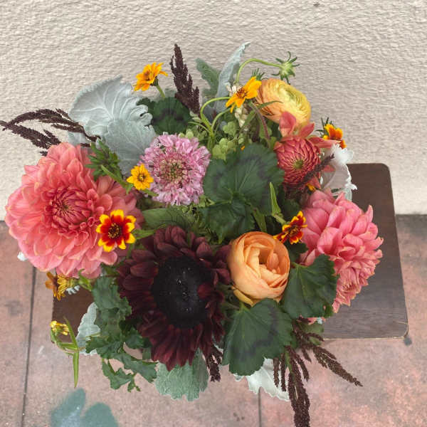 Mixed bouquet with pink and peach blooms in a compact arrangement