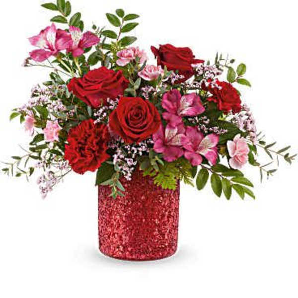 Red roses and pink flowers in a glittery red vase