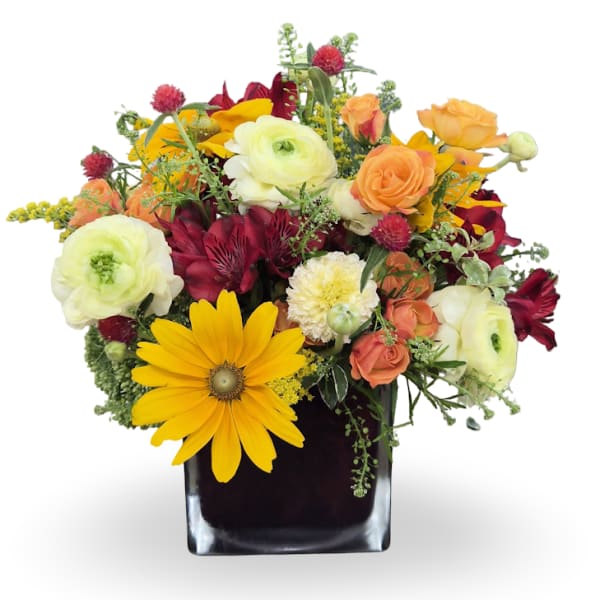 Mixed bouquet in a black square vase with yellow, orange, white, and burgundy flowers