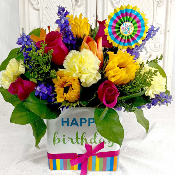 Colorful birthday flower arrangement in a decorated gift box