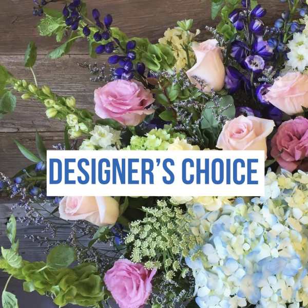 Mixed bouquet with roses, hydrangeas, and purple flowers on wood background
