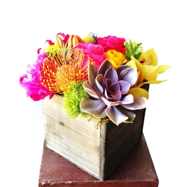 Bright mixed bouquet in a wooden box with a succulent centerpiece