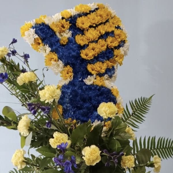 Tall floral standing spray in blue, yellow, and white flowers