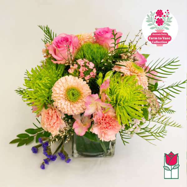 Pink roses and green chrysanthemums in a glass vase