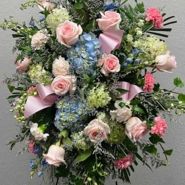 Tall pastel floral standing spray with pink roses and blue hydrangeas