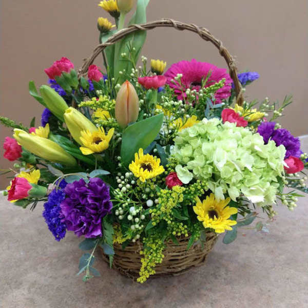 Mixed flower basket with tulips, daisies, hydrangea, and carnations