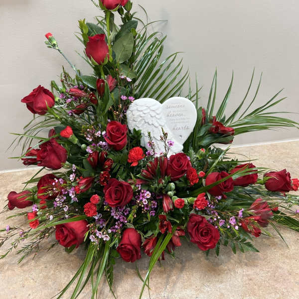 Red rose sympathy arrangement with a white angel heart plaque