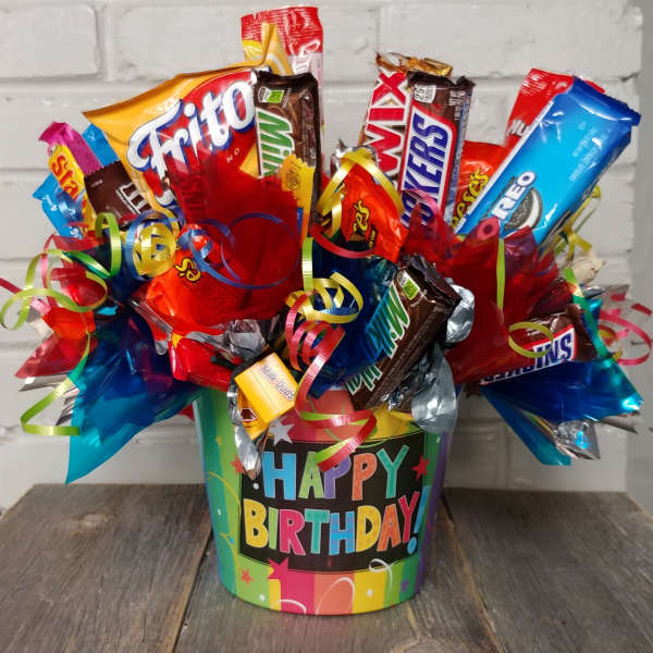 Birthday candy bouquet in a colorful bucket with assorted candy bars and ribbons.