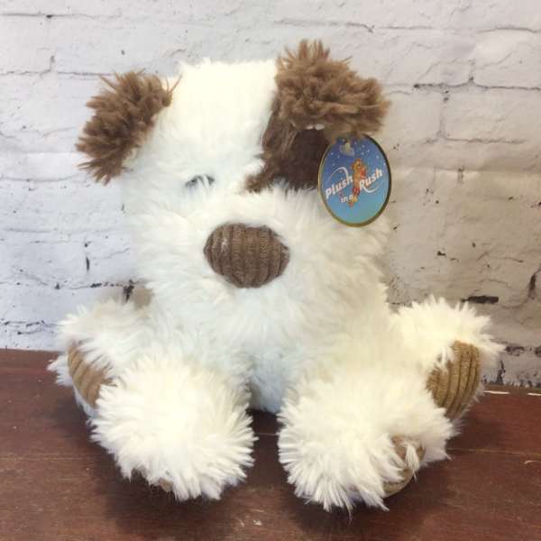 Plush dog toy with white fur and brown ears sitting upright