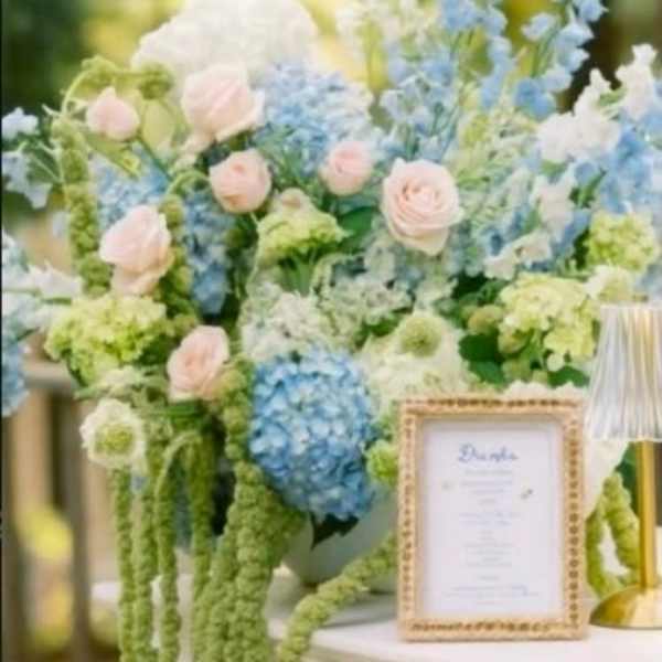 Pastel floral arrangement with blue and pink blooms in a vase