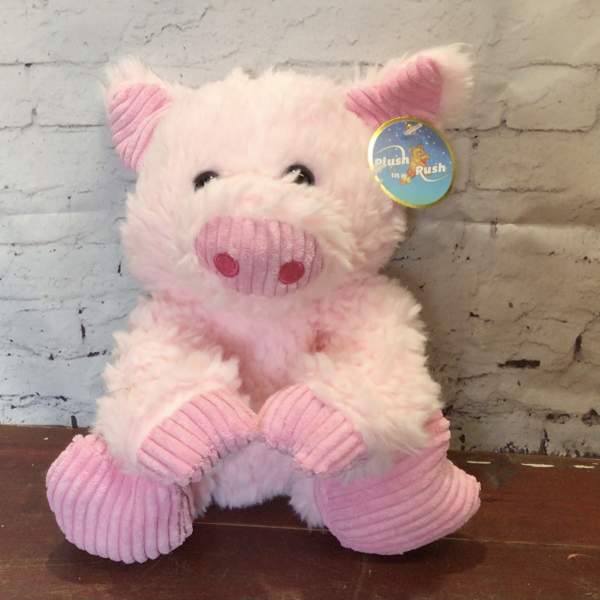 Pink plush pig toy with a tag attached
