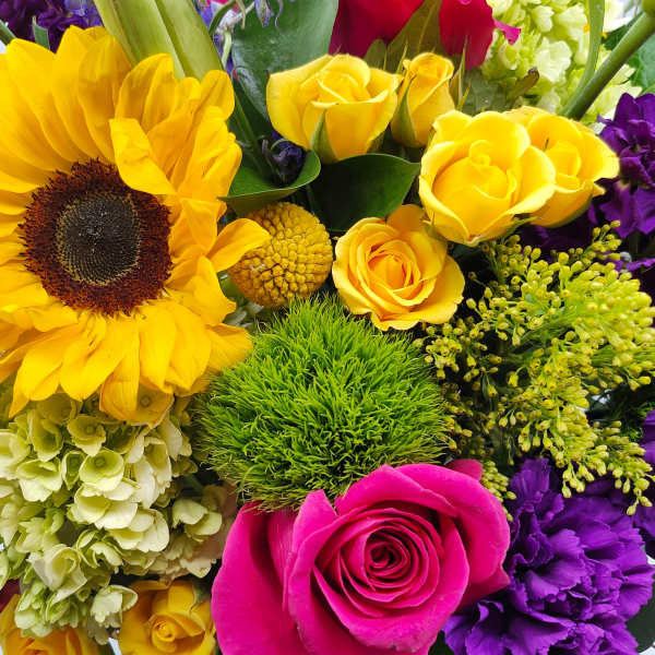 Bright mixed bouquet with sunflowers, roses, and purple blooms