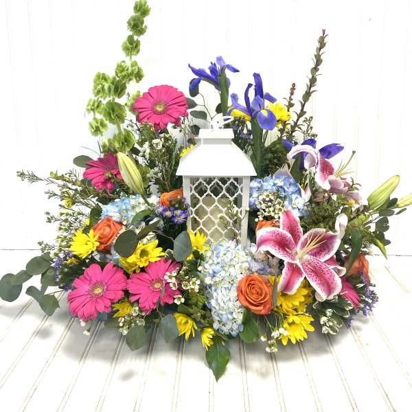 Colorful floral arrangement around a white lantern