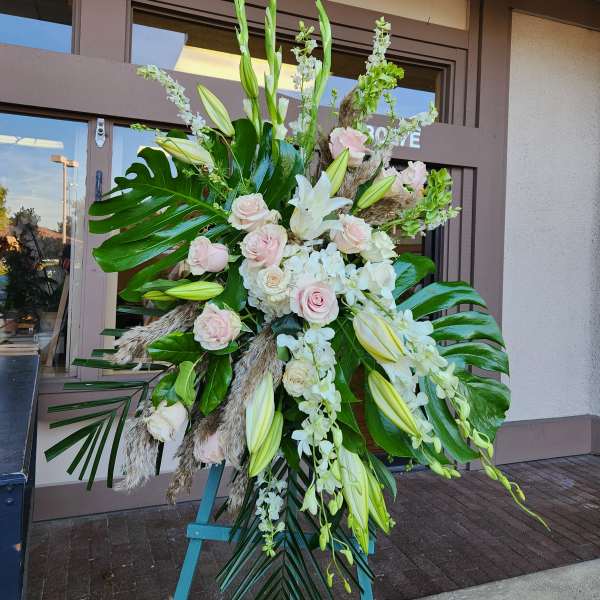 Large standing floral spray with white lilies and pale pink roses