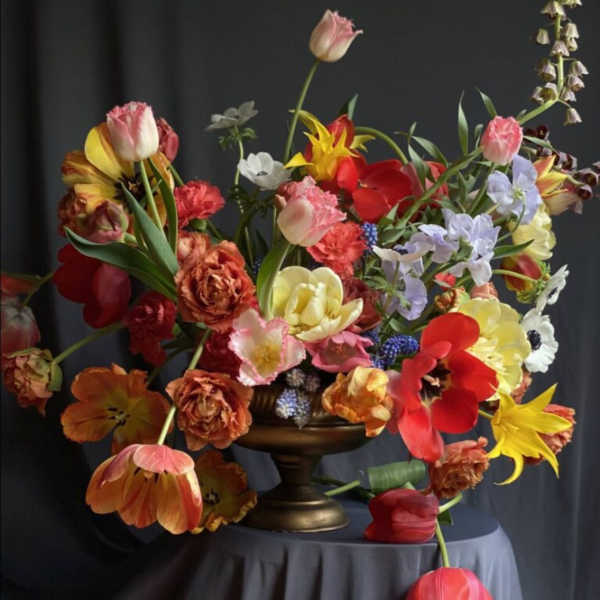 Colorful mixed flower arrangement in a pedestal vase