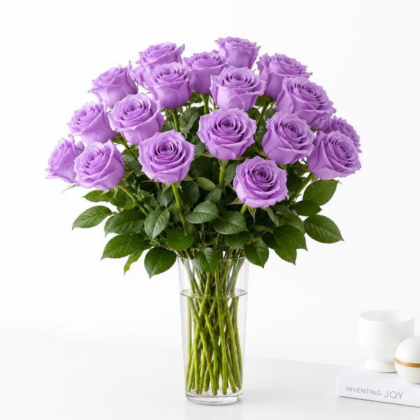 Lavender roses arranged in a clear glass vase