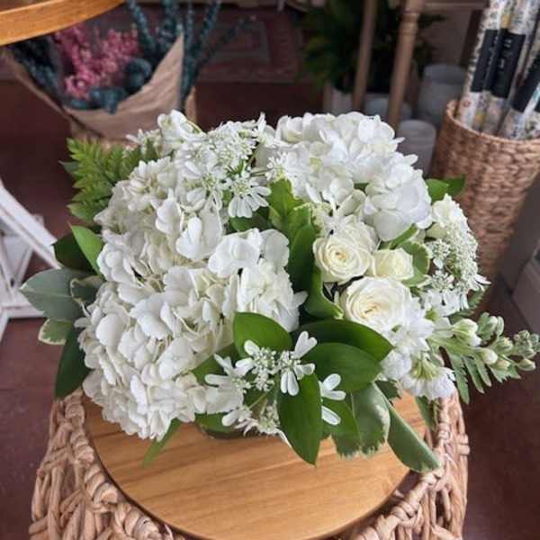 White hydrangea and rose bouquet with green foliage