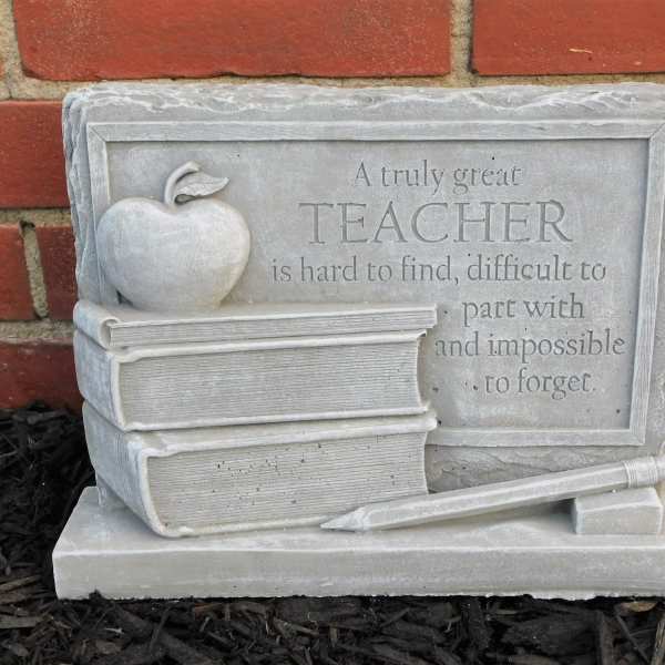 Teacher memorial plaque with books, apple, and pencil