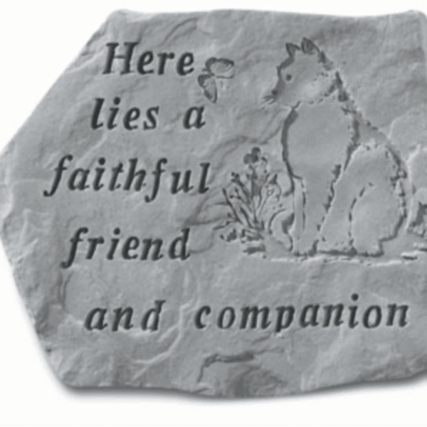 Engraved stone plaque with a cat and the words 'Here lies a faithful friend and companion'