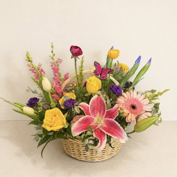 Mixed flower basket with pink lily, yellow roses, and gerbera daisies