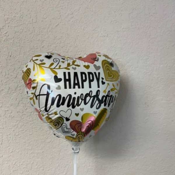 Heart-shaped balloon with "Happy Anniversary" text