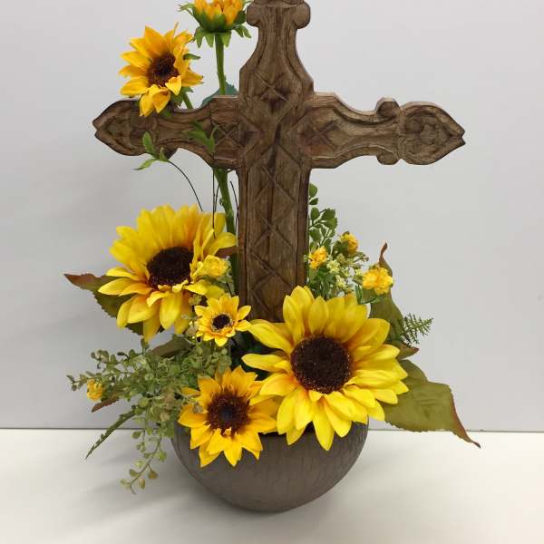 Sunflower arrangement in a wooden cross-shaped holder