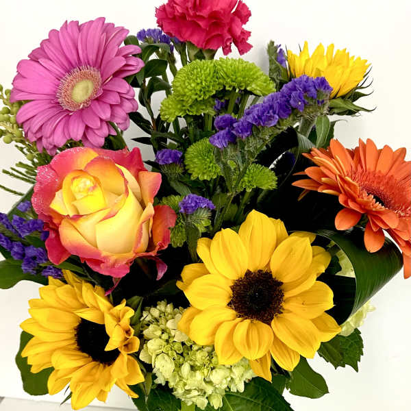 Colorful bouquet with sunflowers, gerbera daisies, a rose, and carnations