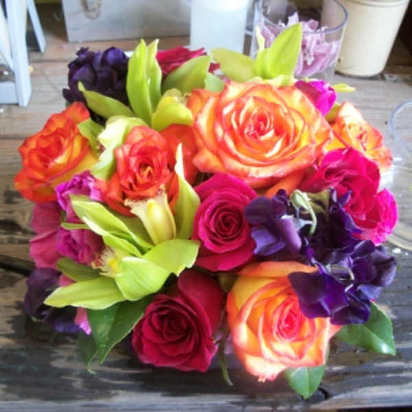 Bouquet of multicolored roses with green orchids