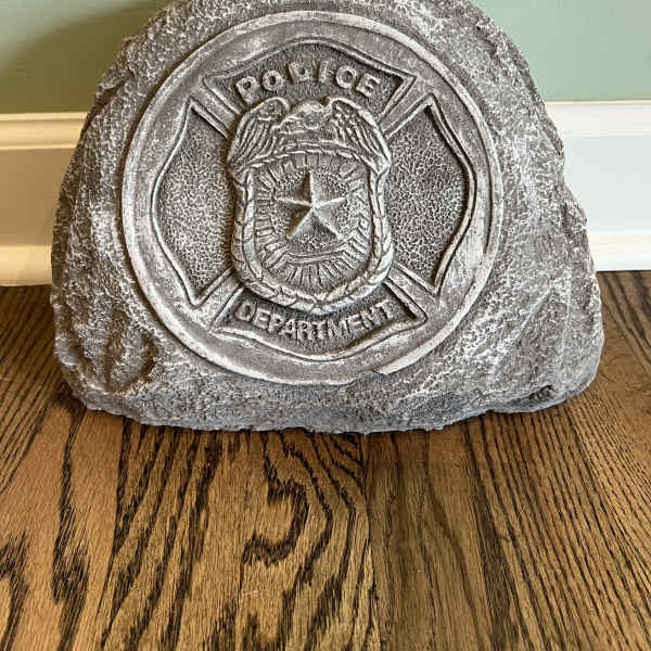 Stone police department plaque on a wooden floor