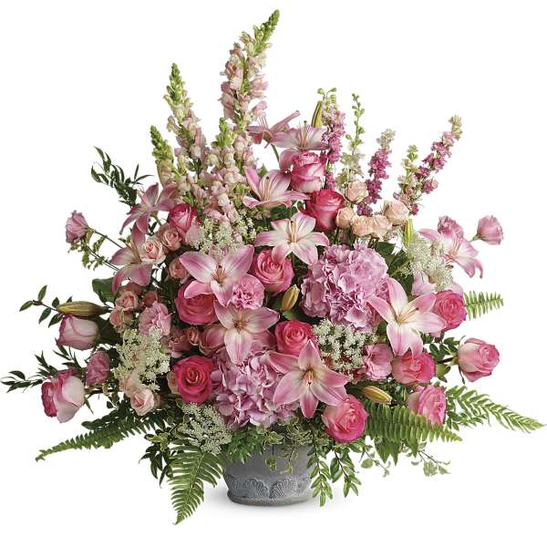Pink roses and lilies arranged in a gray vase