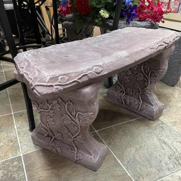 Decorative stone bench with vine carvings
