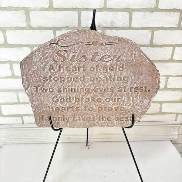 Decorative memorial plaque on a black stand with engraved text
