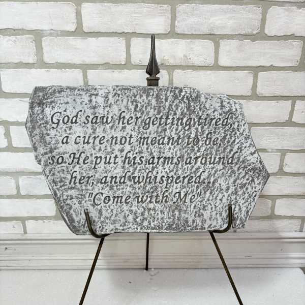 Decorative memorial plaque on a metal stand with a Bible verse