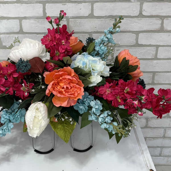 Bright mixed floral arrangement with pink, blue, white, and orange blooms