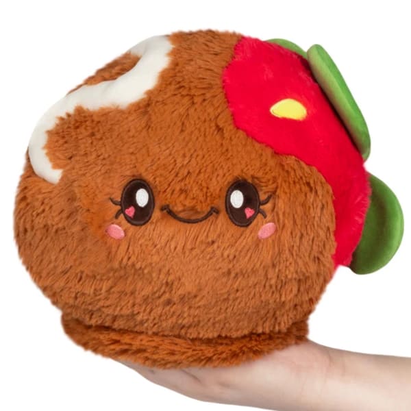 Plush taco-shaped stuffed toy with a smiling face