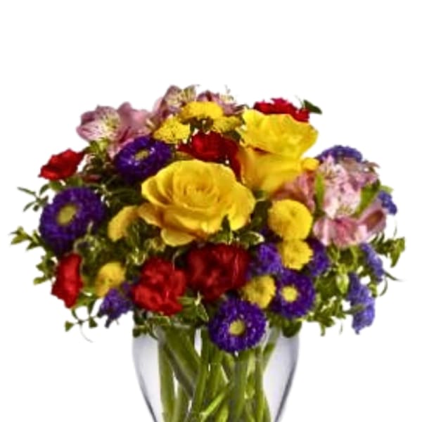 Mixed bouquet of yellow, red, purple, and pink flowers in a clear glass vase